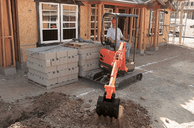 Man using an excavator on a job site