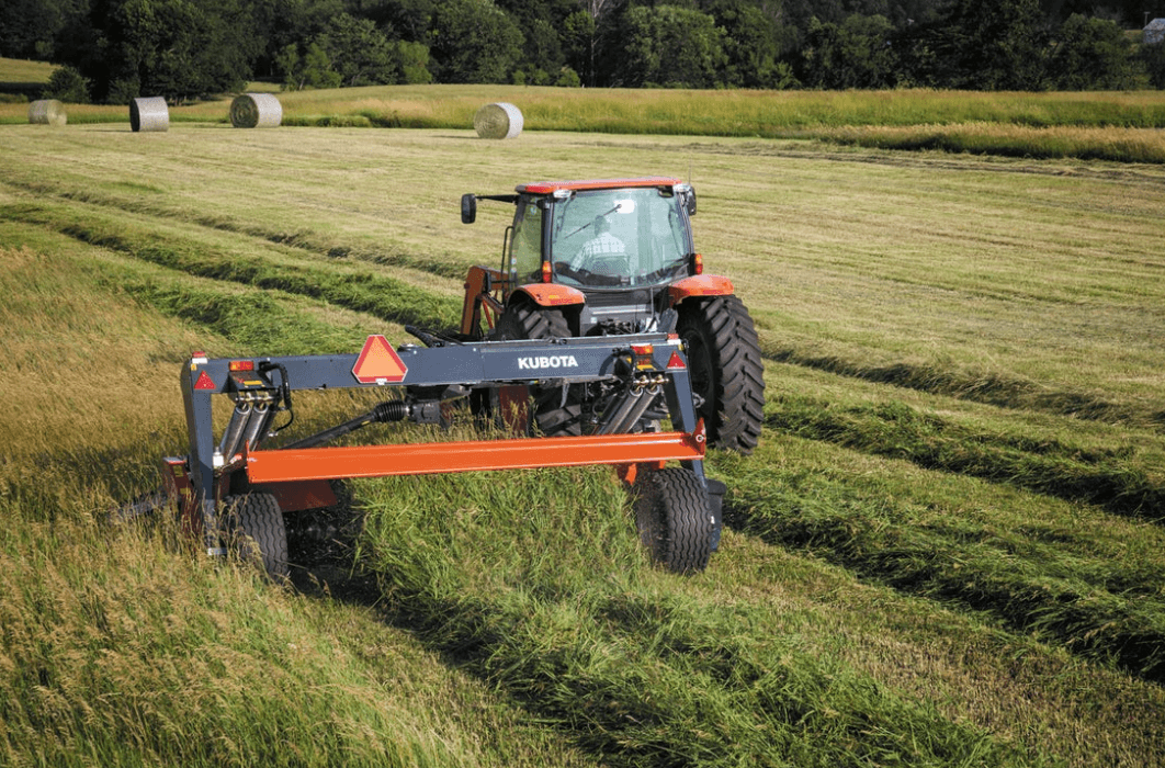 Kubota tractor cutting hay with Kubota hay tool