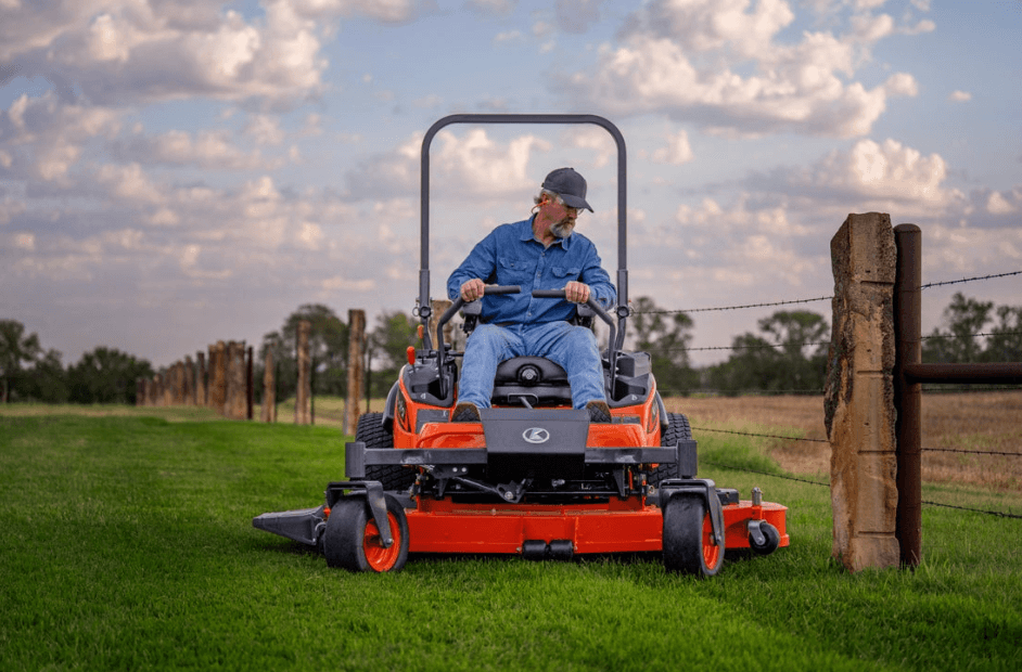 man mowing by fence with kubota zero turn