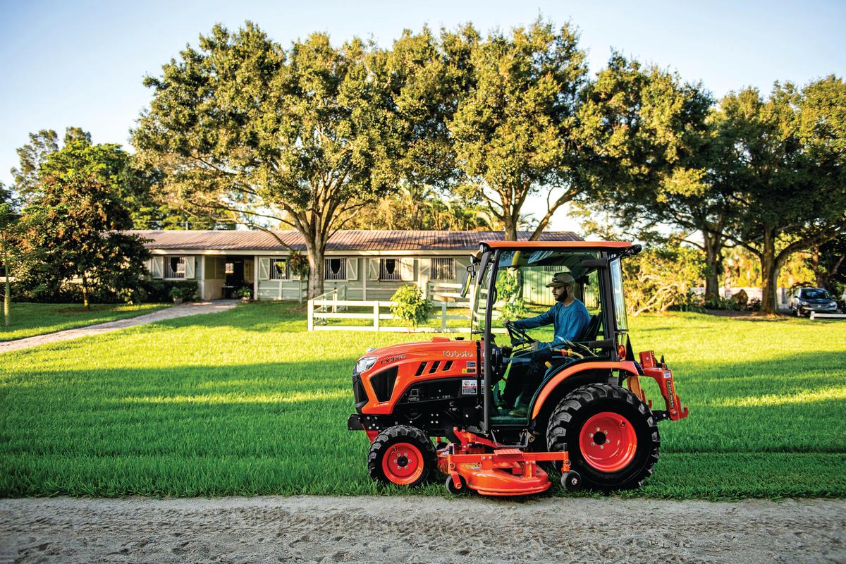 man mowing with lx series tractor