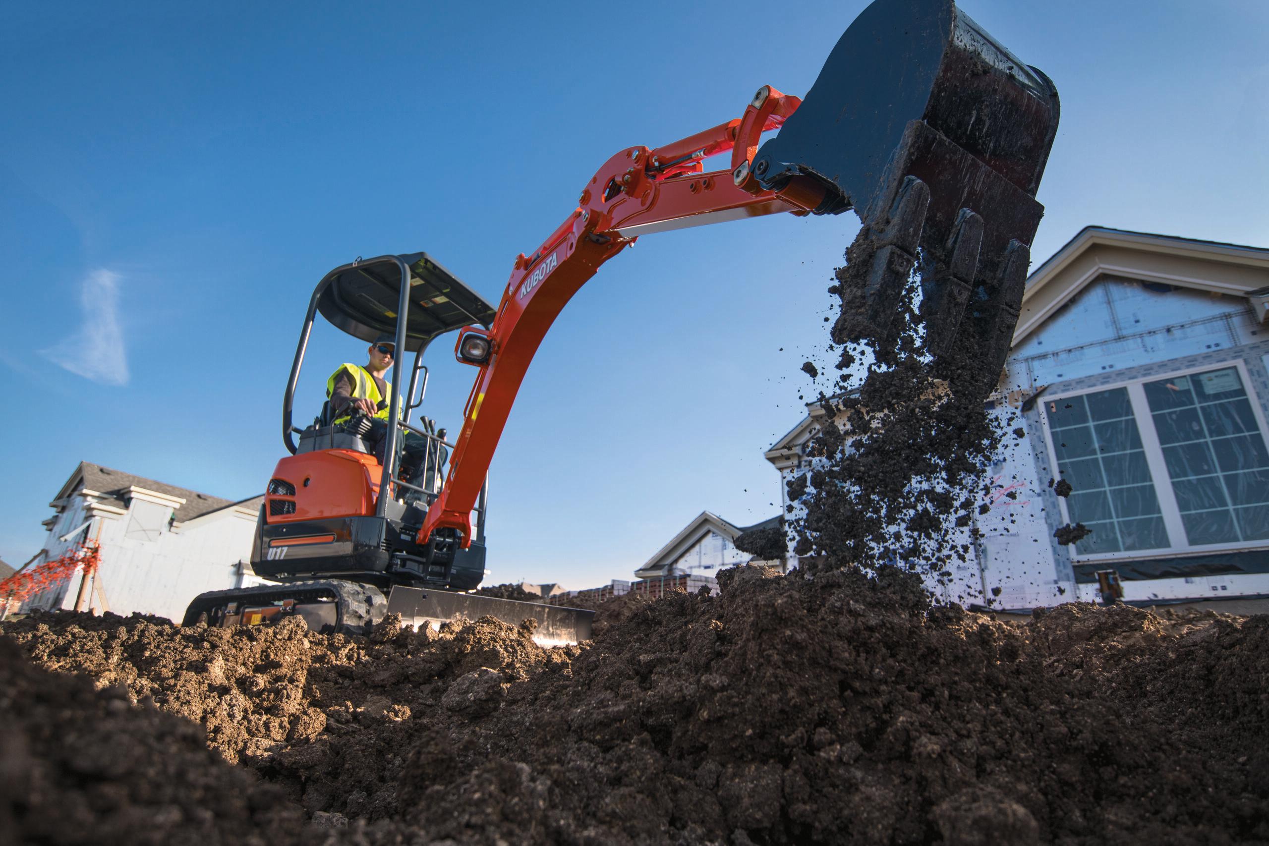 Man operating Kubota U17 house construction
