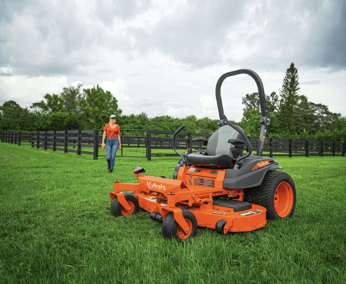 Woman walking towards the zero-turn mower model