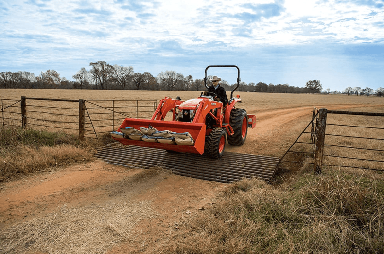 Man moving material with tractor