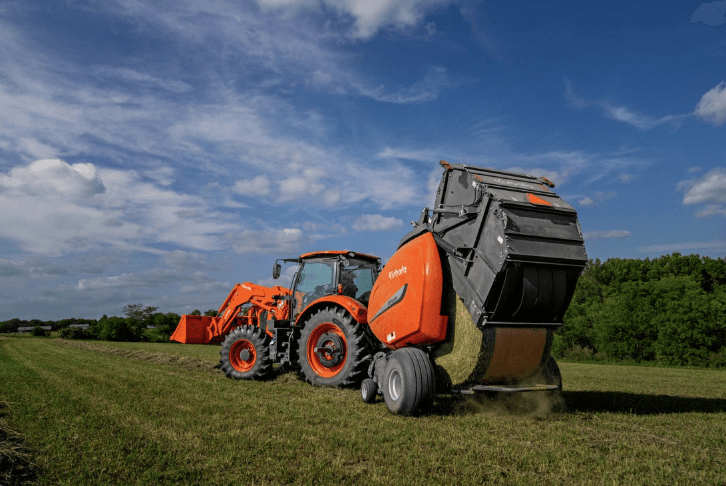 Baler rolling out a fresh hay baler