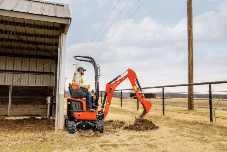 Man excavating alongside a shed
