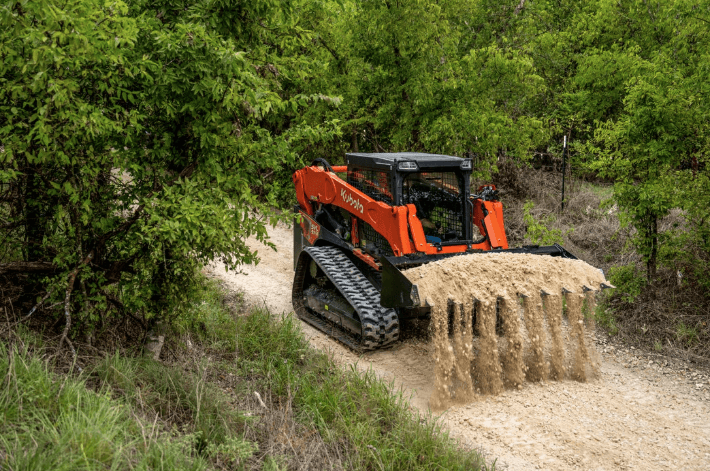 Track loader moving dirt