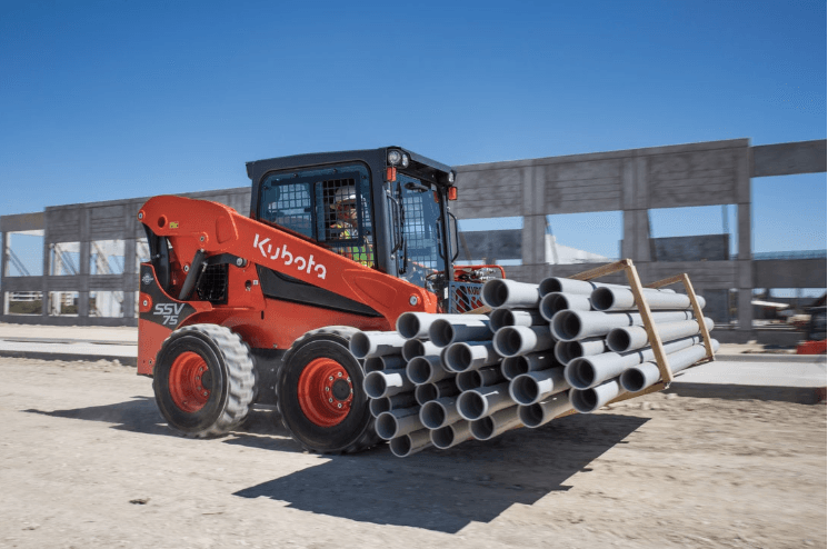 Loader moving pallet of pipes