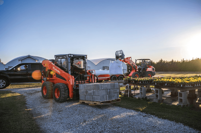 Loader moving pallets of cinder blocks