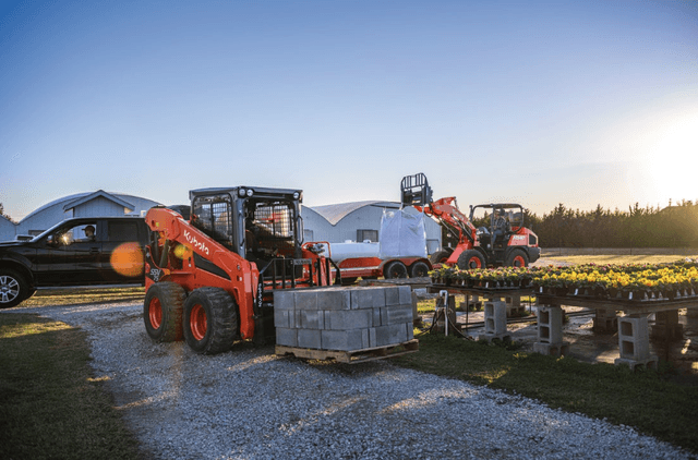 Loader moving pallets of cinder blocks