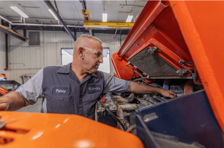 Kubota technician working on a machine