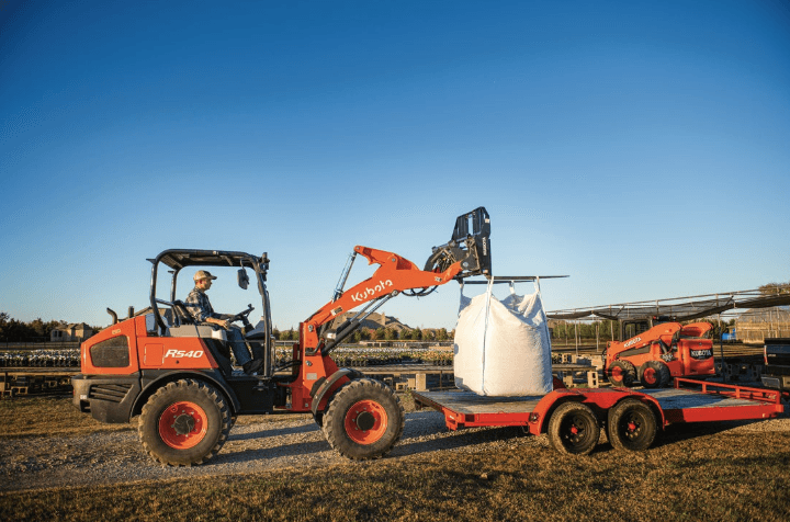 Wheel Loader moving material onto back of trailer