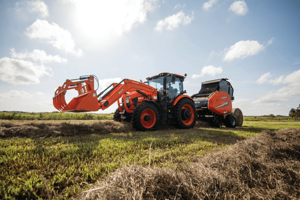 kubota tractor and baler in field