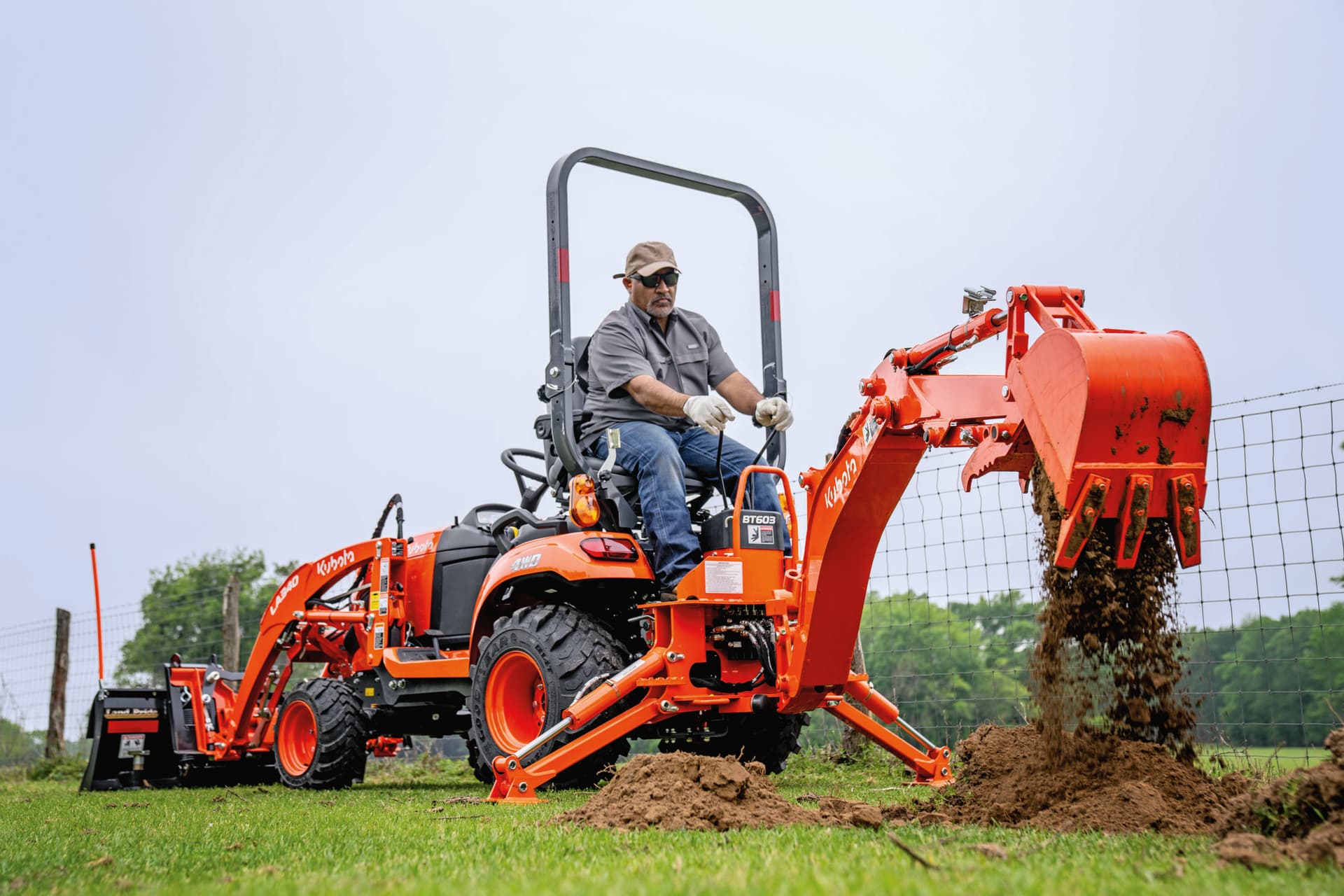 man digging hole with BX23S backhoe