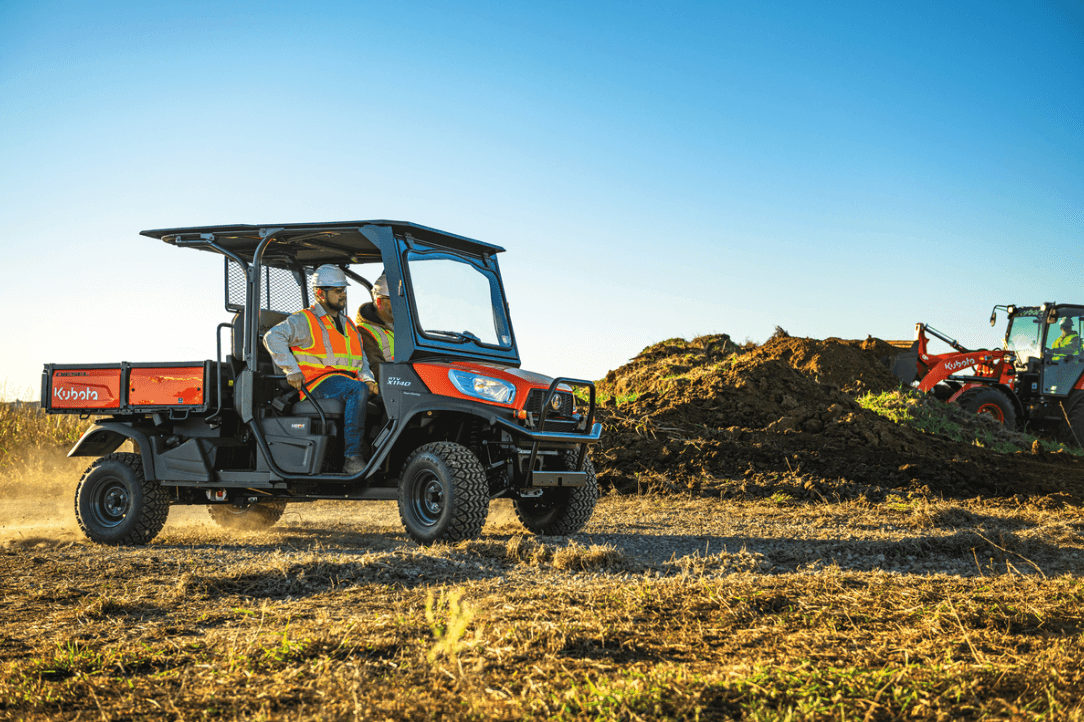 Construction crew driving through site in an utility vehicle
