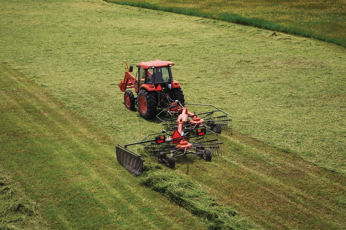 A Kubota Rake organizing freshly cut hay