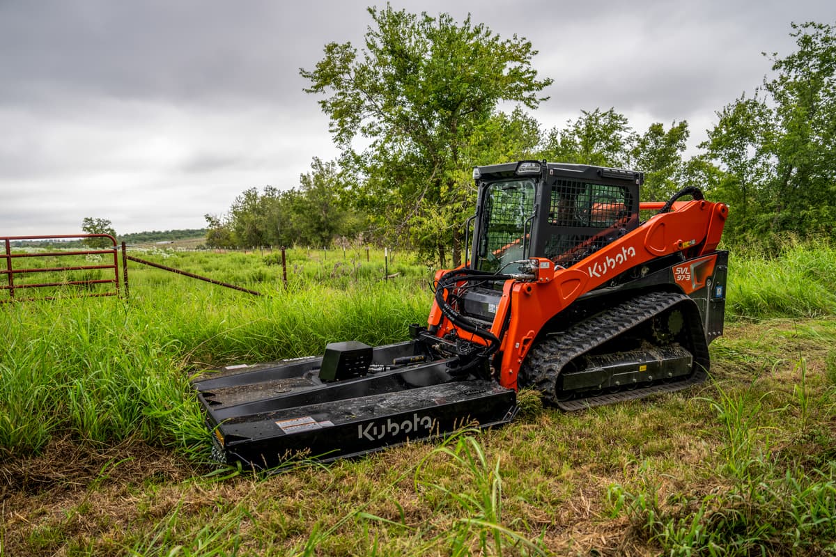 Kubota SVL97-3 with a brush cutter
